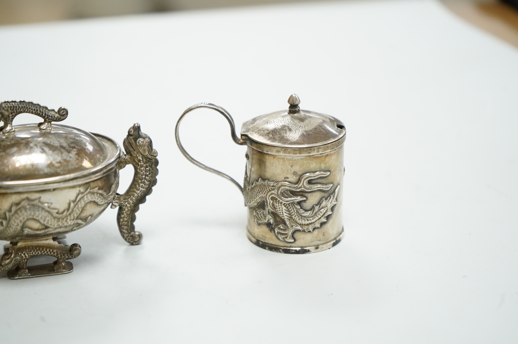 Three early 20th century Chinese export white metal condiments including a drum mustard pot and pepperette by Wang Hing, Hong Kong, pepperette 63mm.